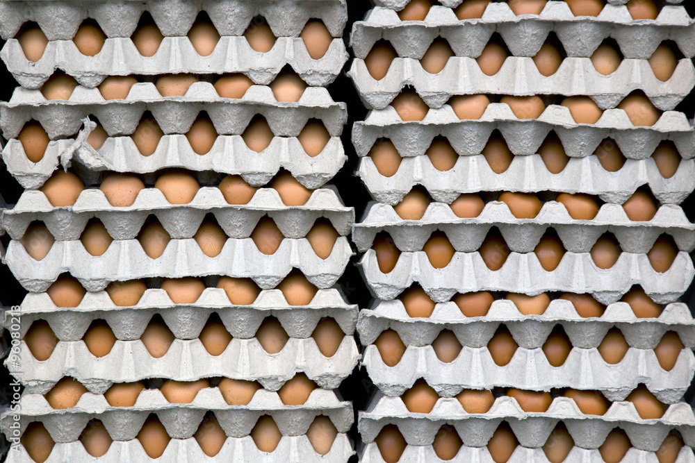 stack of fresh eggs in paper containers carton