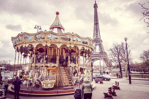 Paris, France - March 18, 2012: Children accompanied by their parents and grandparents play the carousel of the Eiffel Tower in Paris on a wet and cloudy day in March © BlackMac
