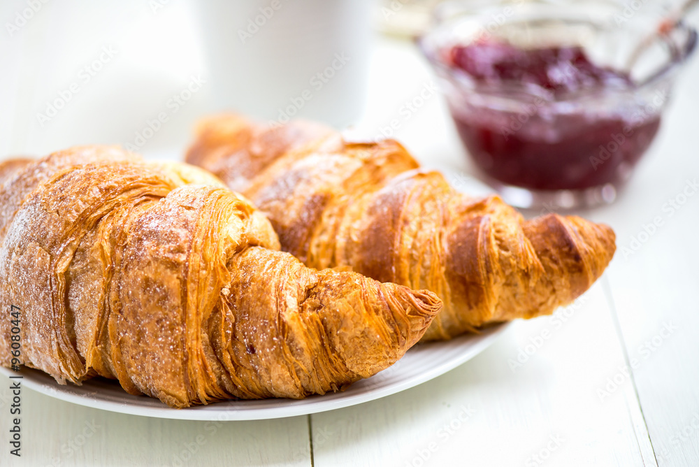 Fresh Croissants with Icing, Cup of Tea and Strawberry Jam