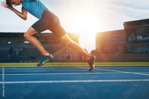 Fototapeta Naklejka Na Ścianę i Meble -  Runner practicing in athletics stadium
