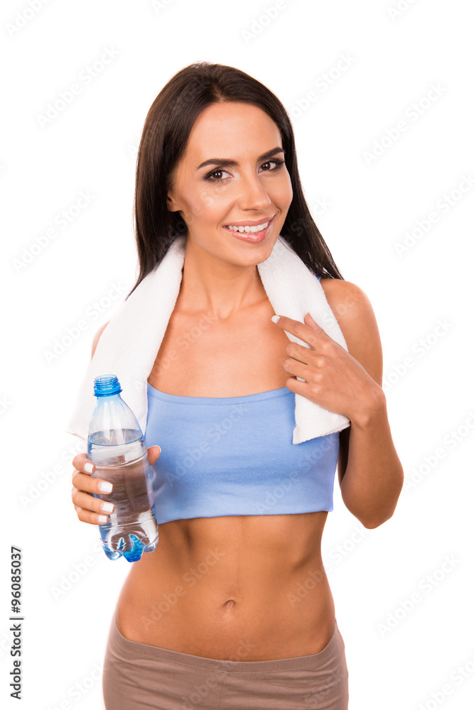 Slender girl with towel holding a bottle with water Slender girl with towel holding a bottle with water