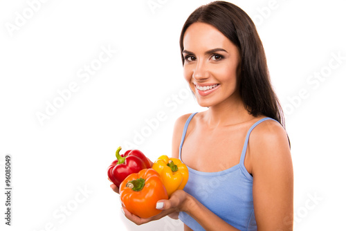 Happy cute young woman with peppers