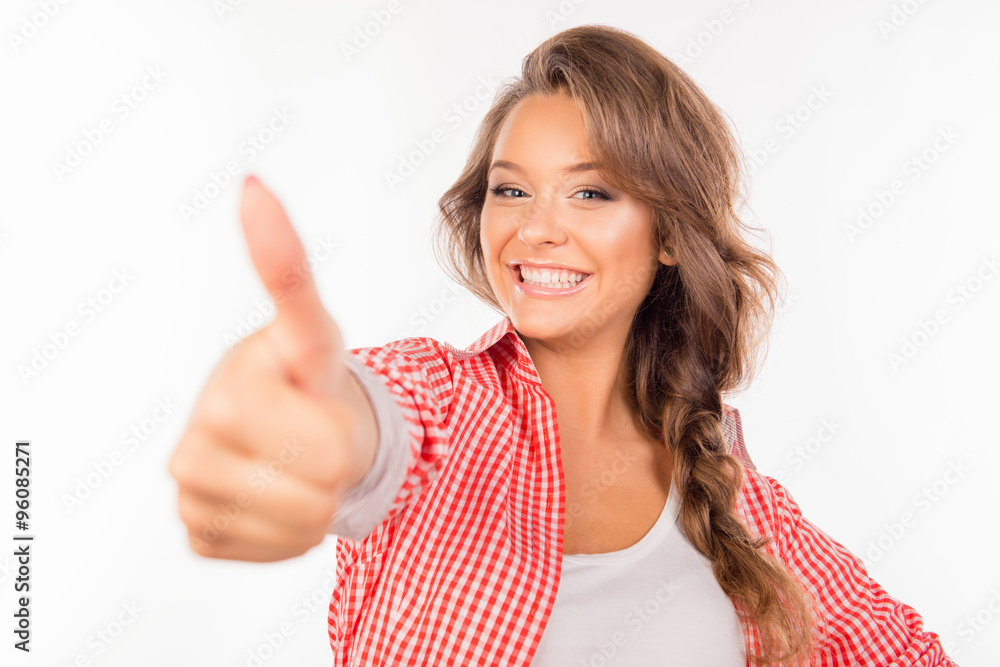 Happy cute girl showing thumb up and smiling Happy cute girl showing thumb up and smiling