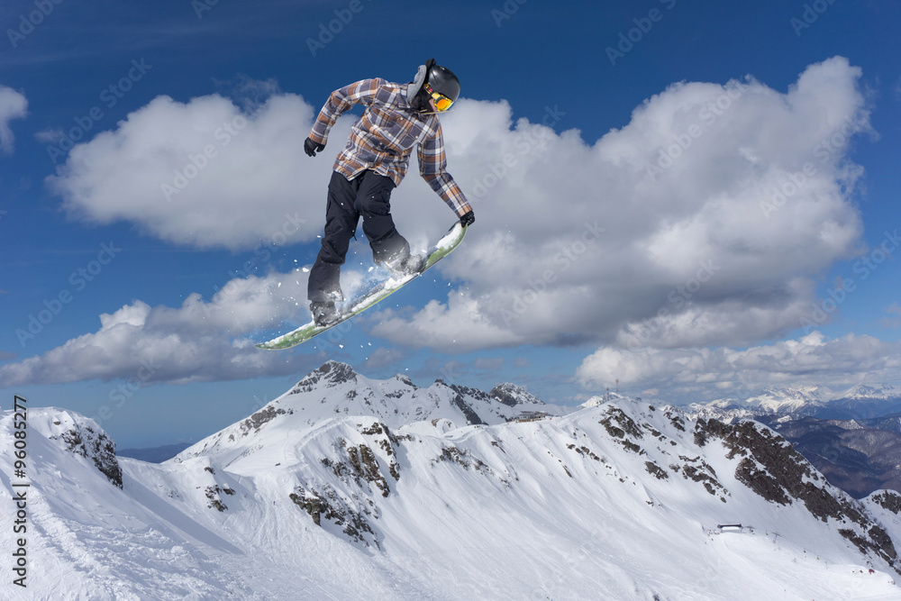 flying snowboarder on mountains