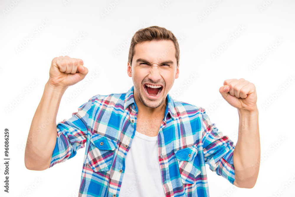 Young furious man shouting and showing fists Young furious man shouting and showing fists