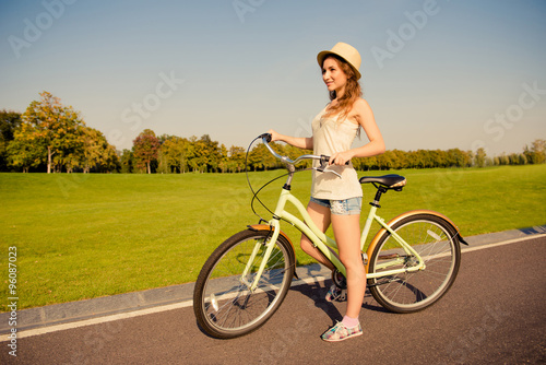 happy cute girl with bike walking on park