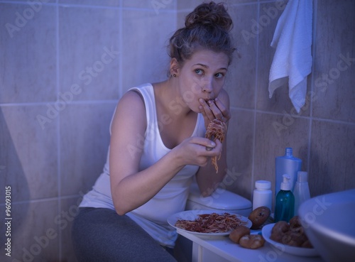 Girl stuffing with spaghetti photo