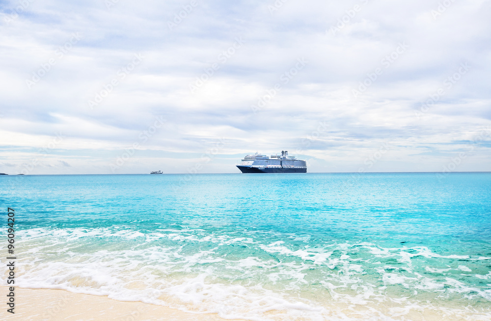 Cruise ship and tender on a light blue sea at Half Moon Cay in t Cruise ship and tender on a light blue sea at Half Moon Cay in t