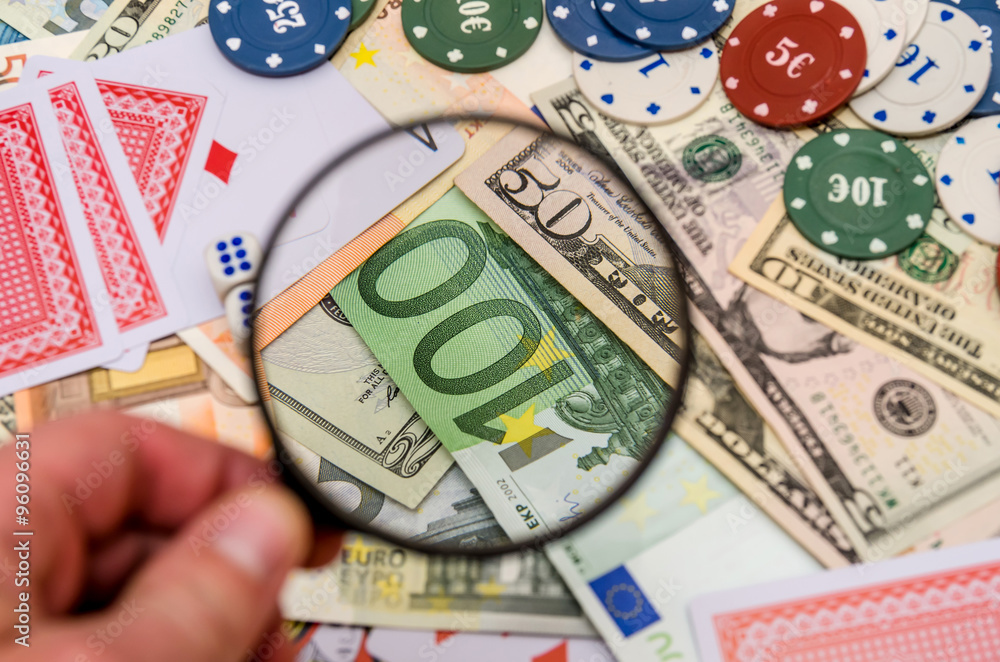 play cards, poker chips, money, with magnifying glass play cards, poker chips, money, with magnifying glass