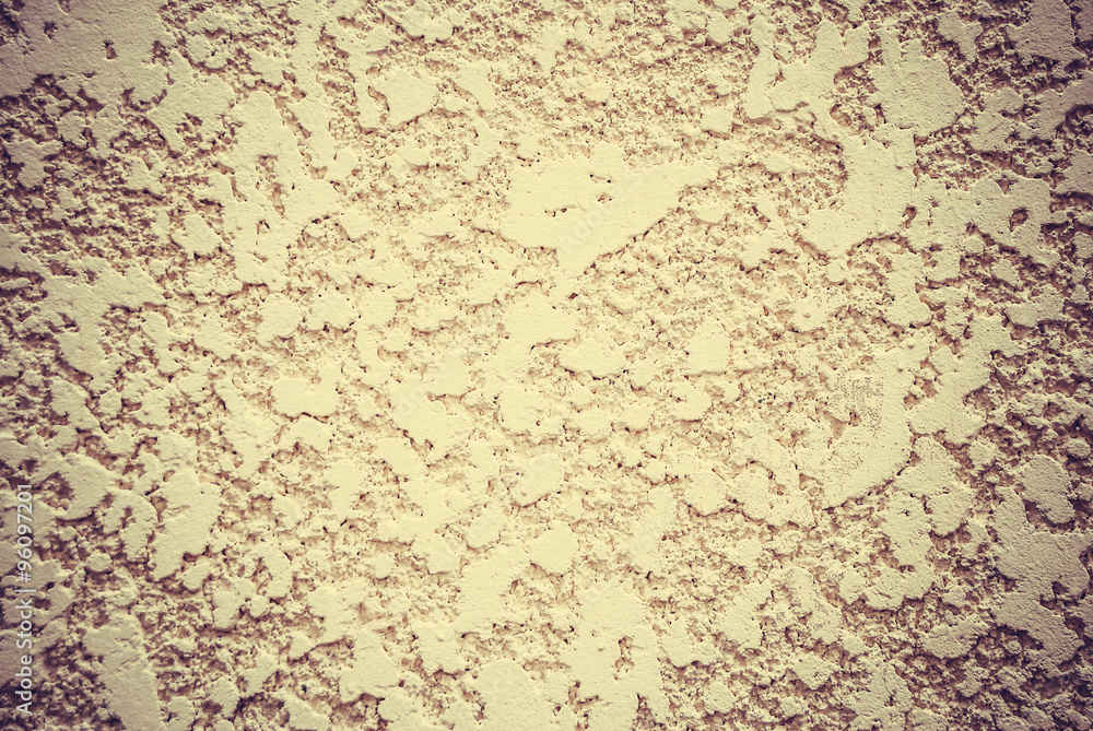 Decorative plaster wall with yellow structure as texture
