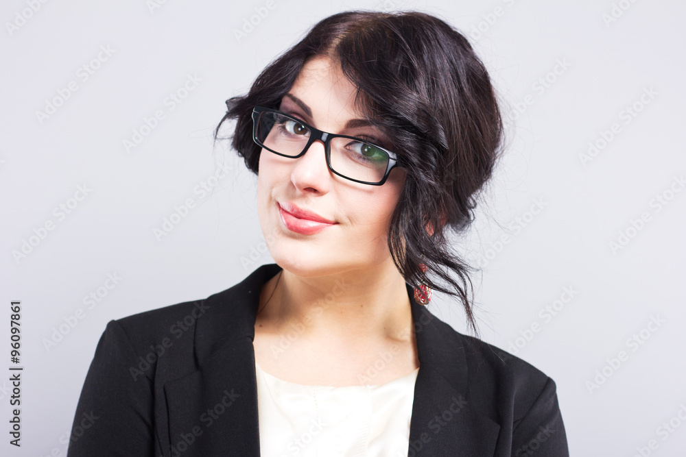 Business woman in a narrow black jacket. Successful woman. Beautiful brunette. Portrait of a beautiful girl in glasses
