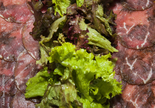 Beef carpaccio on a table in a restaurant photo