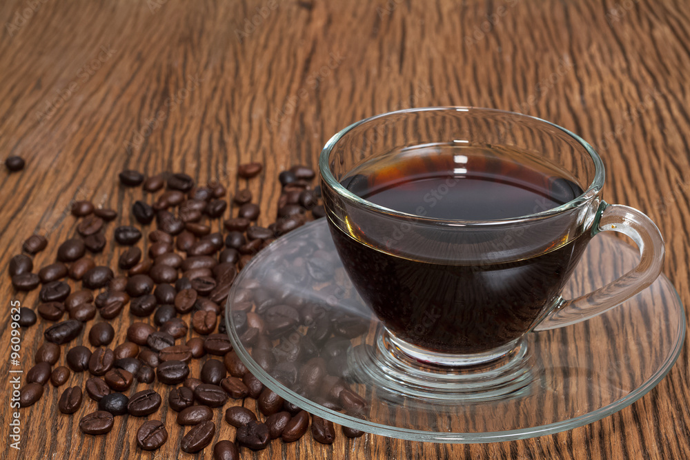 Coffee cup and coffee beans on table Coffee cup and coffee beans on table