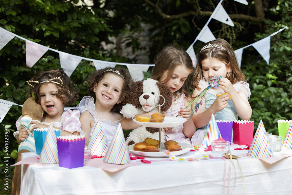 Group of young girls dressed up at a garden party. Group of young girls dressed up at a garden party.