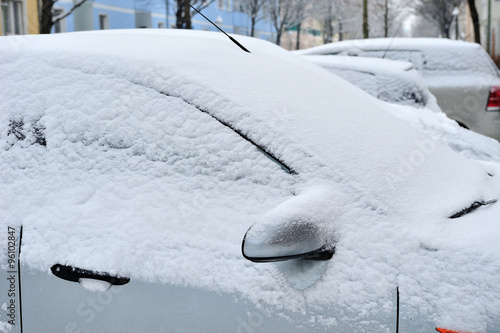 Cars covered with snow