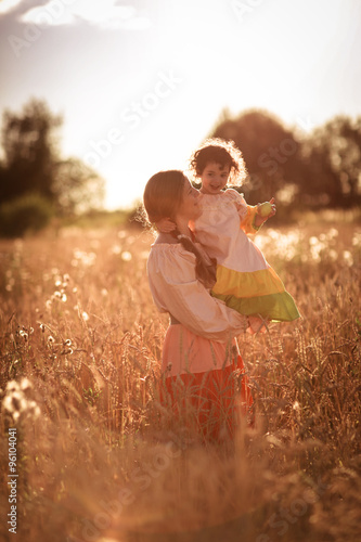 happy mother communication with daughter in a wheat field