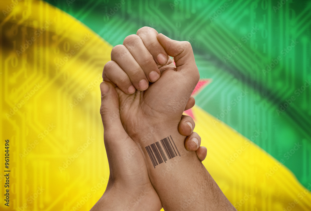 Barcode ID number on wrist of dark skinned person and national flag on background - French Guiana