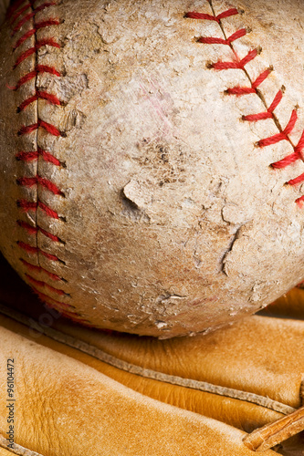 well-used softball in mitt