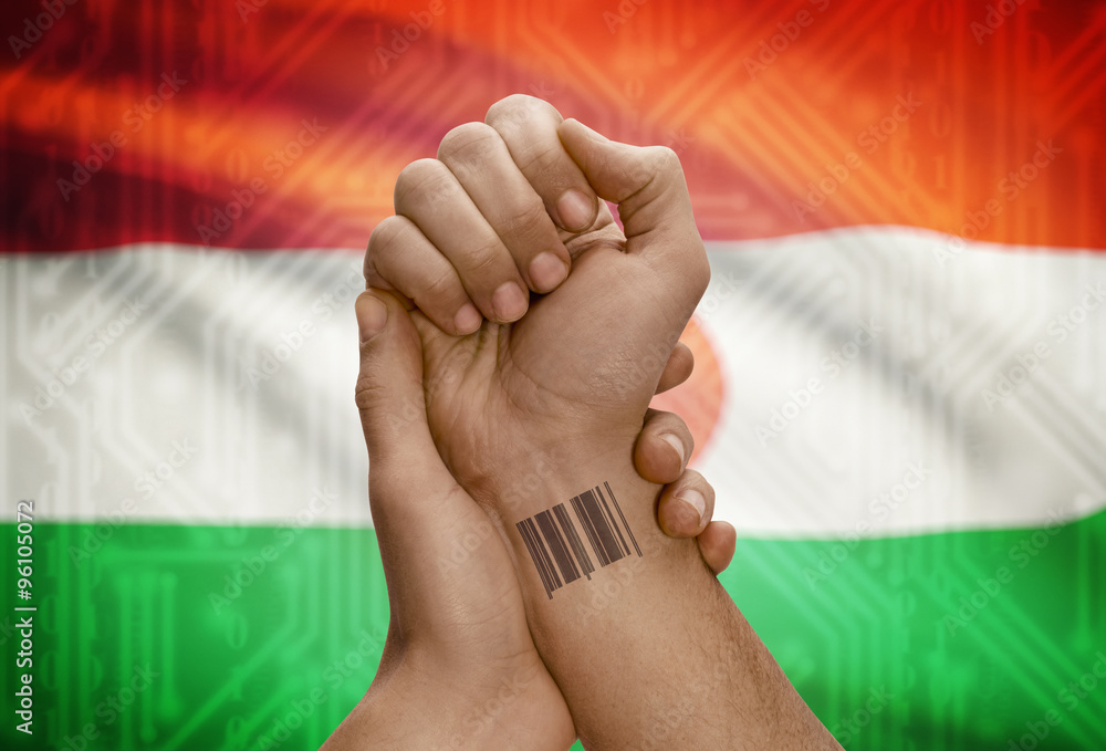 Barcode ID number on wrist of dark skinned person and national flag on background - Niger