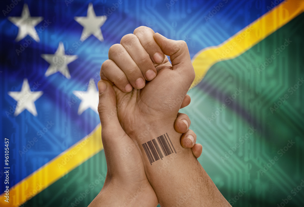Barcode ID number on wrist of dark skinned person and national flag on background - Solomon Islands
