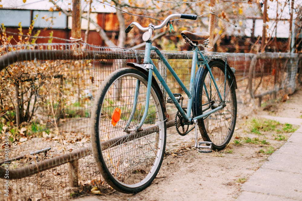 Parked vintage old bicycle bike in courtyard.