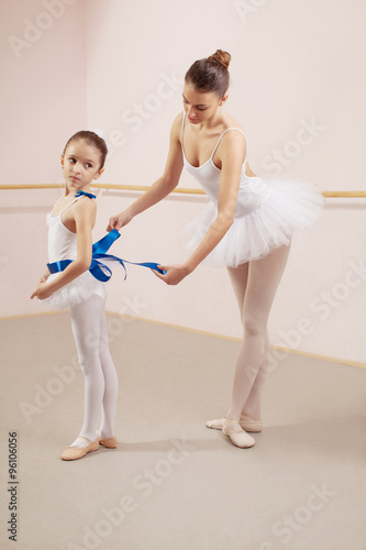 Prepariing for ballet class in dance studio