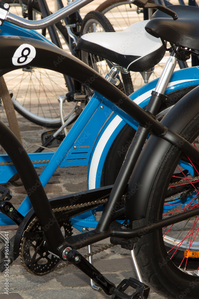 Bicycles for rent - details of black and blue bicycle Bicycles for rent - details of black and blue bicycle