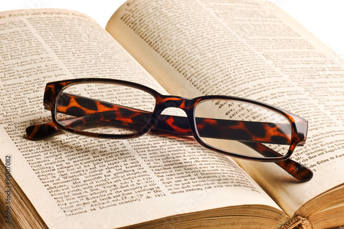 Old book with glasses