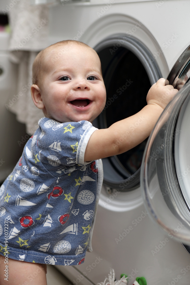 Smiling baby with washing machine Smiling baby with washing machine