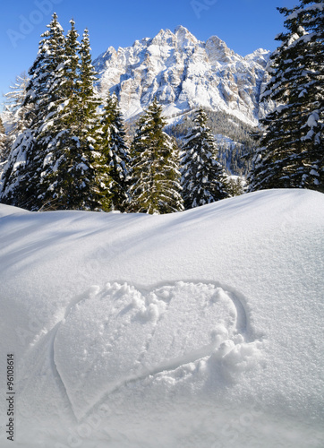 Winter mountain landscape with heart on the snow