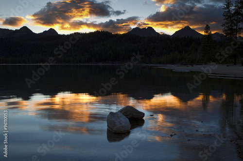 Two rocks in lake at sunset.