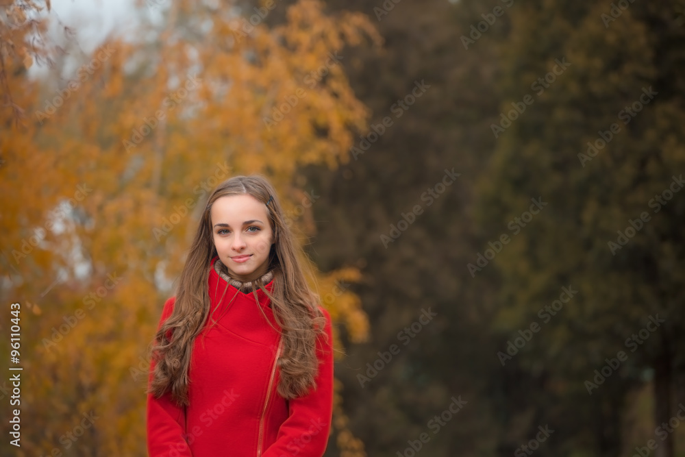 Young pretty woman at the autumn park.