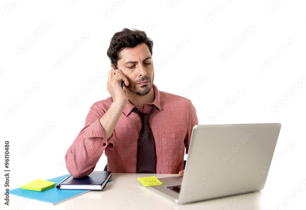 attractive businessman working at office desk texting with mobile phone in front of computer laptop looking busy attractive businessman working at office desk texting with mobile phone in front of computer laptop looking busy