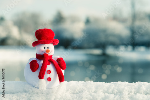 Snowman and winter landscape in the background © nioloxs