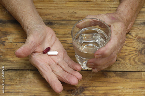 hands of senior woman with pills