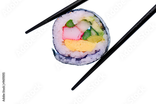 Sushi roll with black chopsticks isolated on white background