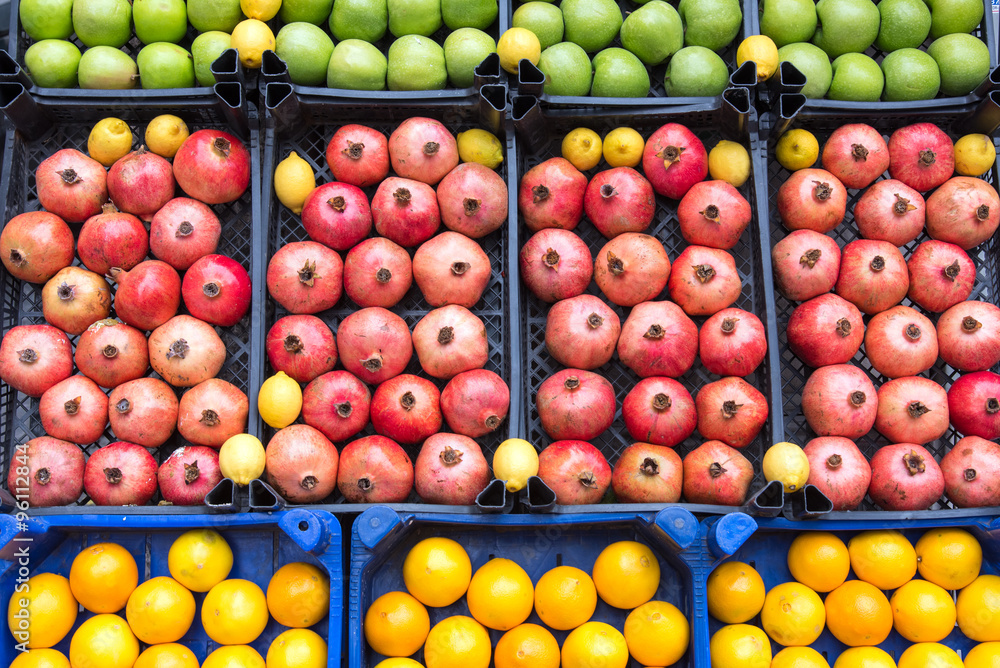 Pomegranates, apples and lemons for sale at a market Pomegranates, apples and lemons for sale at a market
