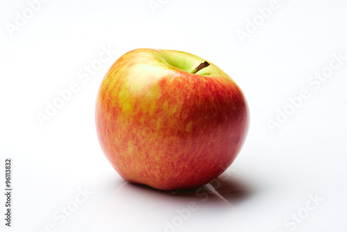Red and yellow apple on white