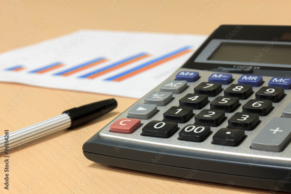 selective focus calculator,pen,chart on wood background. selective focus calculator,pen,chart on wood background.