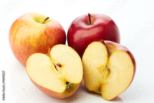 Two apples and half on white