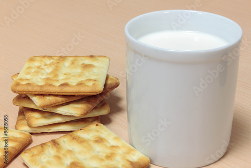 milk,glass,cracker on wood background.