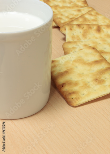 Selective focus craker  and milk  on wood background. photo