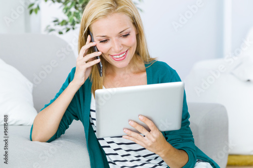 Free Download Pretty young woman working and using her mobile phone. - GFXLoad