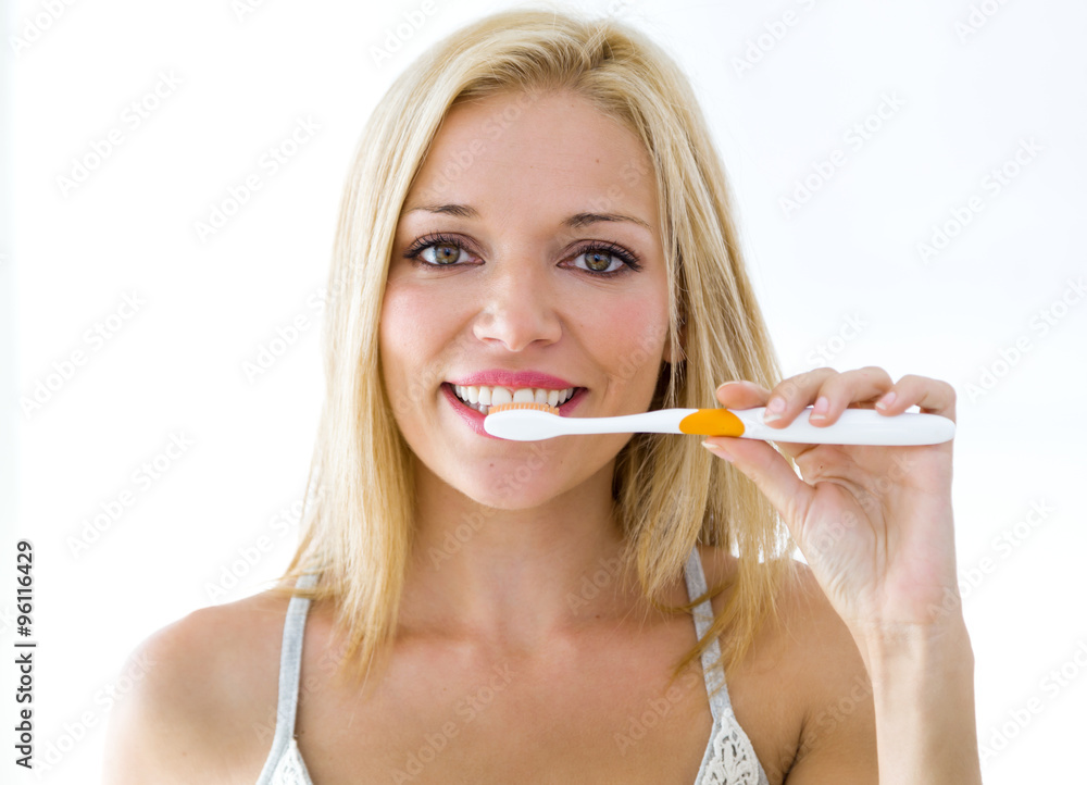 Pretty young blonde woman cleaning her teeth. Pretty young blonde woman cleaning her teeth.