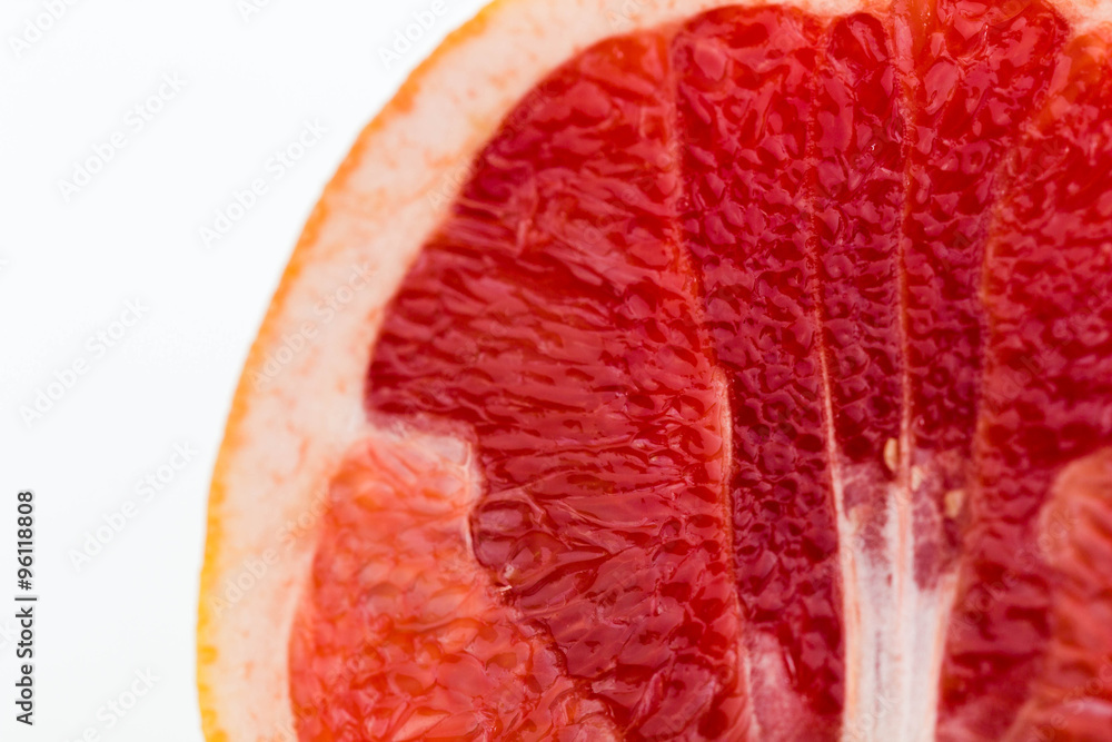 Slice of fresh red grapefruit, close-up, white background. Slice of fresh red grapefruit, close-up, white background.