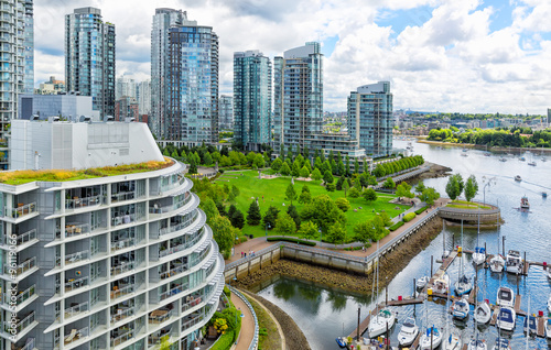 Vancouver aerial view of of glass towers and waterfront park along a marina with boats photo