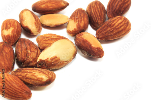Selective focus almonds on white background.