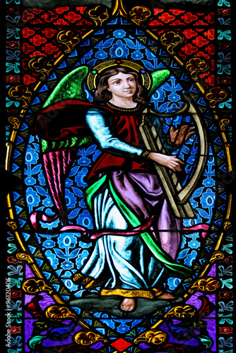 Angel with harp: beautiful stained glass window from Santa Maria de Montserrat Abbey (Catalonia, Spain).