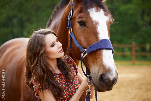 Beautiful young woman with a horse outdoor © fyb