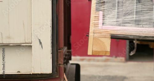 Forklift loading cargo on a container